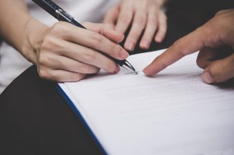 Women,People,Hand,Signing,A,Contract,On,Document,For,Building